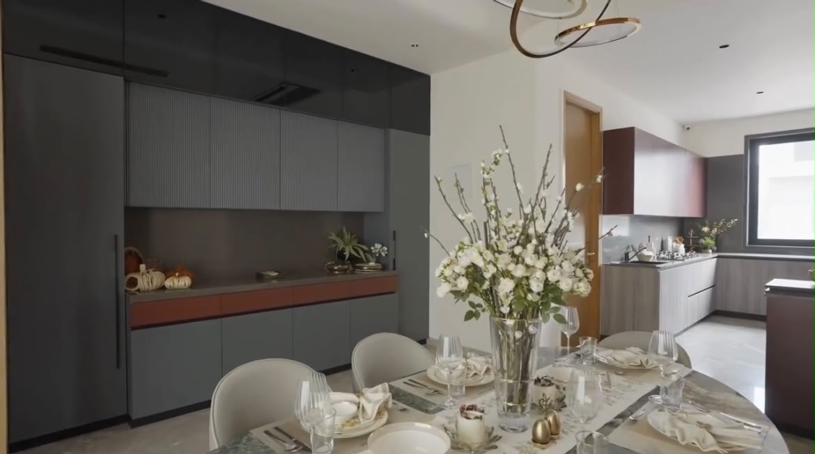 Dining and kitchen in deep grey joinery with terracotta counter band