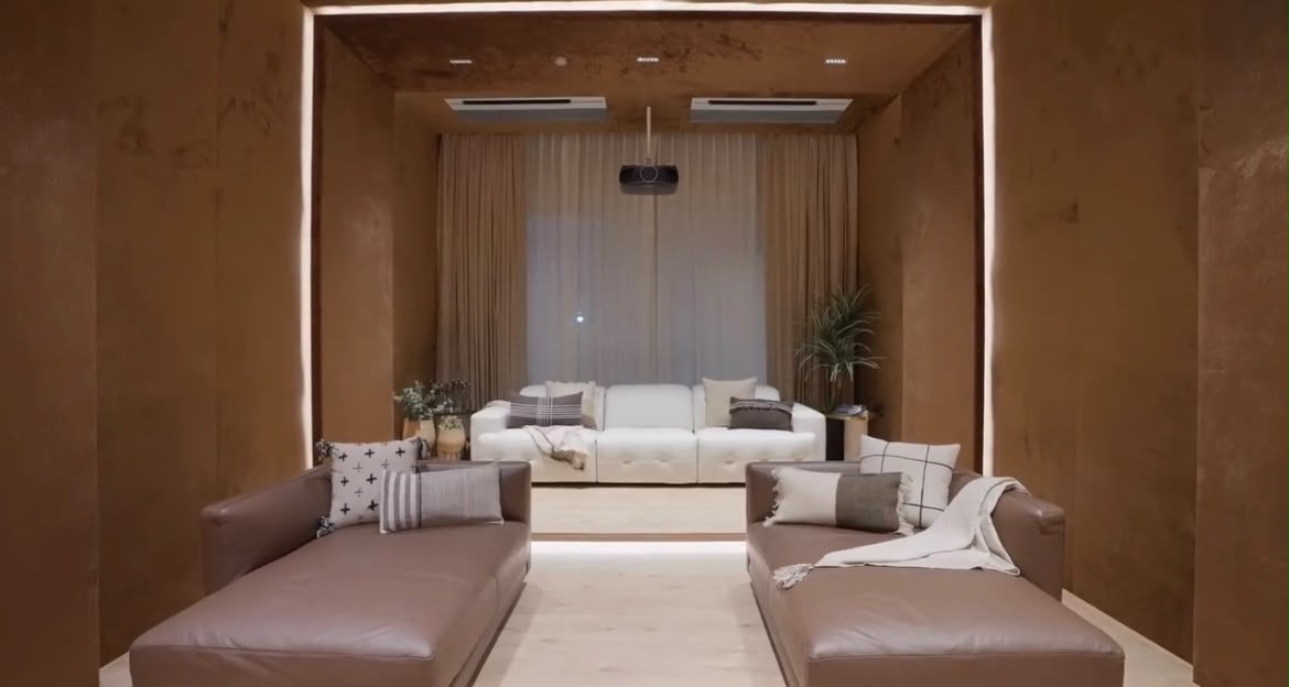 Media lounge in warm earthen plaster with cove lighting